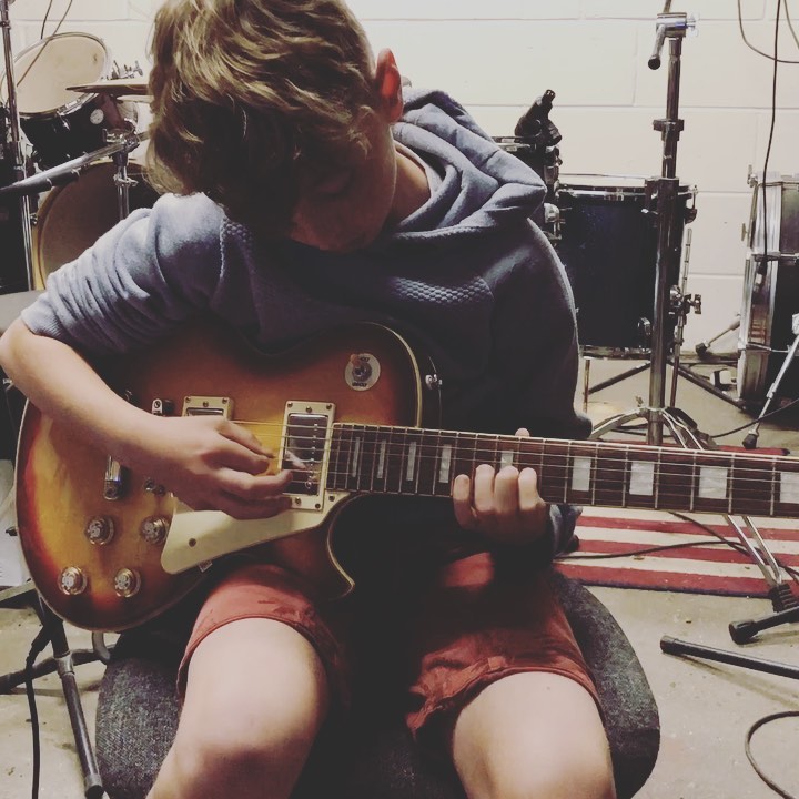 Josh James teaching guitar technique at the studio
